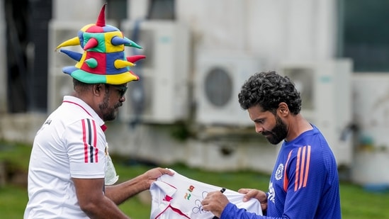 India's Ravindra Jadeja signs autograph for a Sri Lankan fan during Day 2 of the first Test cricket match between India and Sri Lanka, in Galle