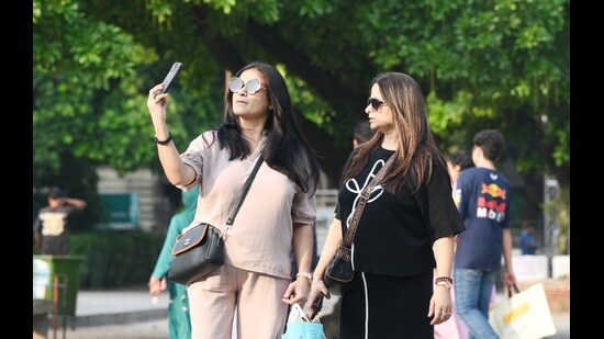 Residents taking selfie at Sector 17 Plaza in Chandigarh on Sunday.