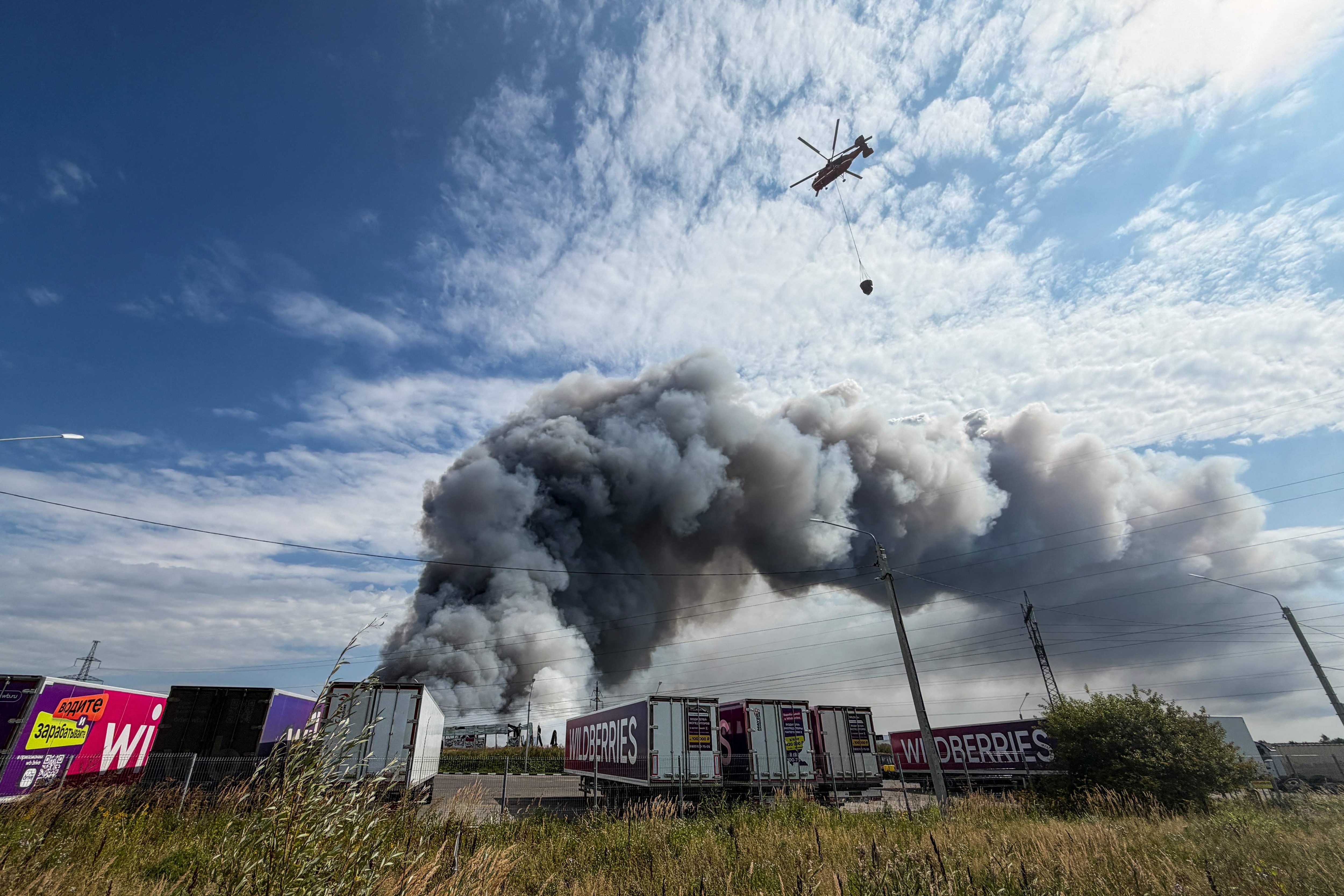 A firefighting helicopter prepares to drop a load of water during a fire at Russian e-commerce firm Wildberries' logistics complex near the town of Podolsk, outside Moscow on August 16. (AFP) A firefighting helicopter prepares to drop a load of water during a fire at Russian e-commerce firm Wildberries' logistics complex near the town of Podolsk, outside Moscow on August 16. (AFP)