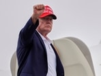 US President Donald Trump gestures as he boards Air Force One at Morristown Airport in Morristown, N.J. 