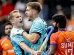 England's Stuart Rushmere (L) and Nicholas Bandurak celebrate their first goal vs India at the Hockey World Cup. (AFP)