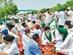 Farmers sit on a road during their gathering near the Khanauri-Data Singhwala border as part of the ‘Kisan Bachao Padyatra’ towards Delhi . (PTI)