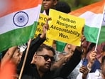 Protesters celebrate the resignation of Dharmendra Pradhan as Union education minister, in Mumbai last month.