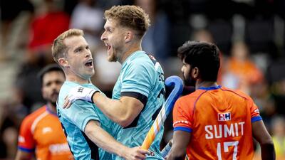 England's Stuart Rushmere (L) and Nicholas Bandurak celebrate their first goal vs India at the Hockey World Cup. (AFP) England's Stuart Rushmere (L) and Nicholas Bandurak celebrate their first goal vs India at the Hockey World Cup. (AFP)