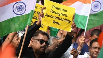 Protesters celebrate the resignation of Dharmendra Pradhan as Union education minister, in Mumbai last month. (AFP) Protesters celebrate the resignation of Dharmendra Pradhan as Union education minister, in Mumbai last month. (AFP)