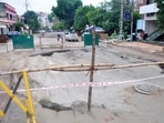 A stretch of road caved in at Vikas Nagar, Sector 2, in Lucknow on Monday, following heavy rainfall amid ongoing sewage work (Deepak Gupta/HT)