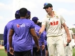 Australian captain Pat Cummins, right, congratulates members of the Bangladesh team following their nine wicket loss on day four of the first cricket test in Darwin