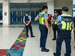 Philippine police gather at a school following a shooting in Zamboanga on August 18, 2026. A student was shot dead at a high school in the southern Philippines on August 18 before the alleged killer took his own life, police said. (Photo by Roel Parreno / AFP)(AFP)