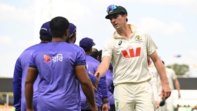 Australian captain Pat Cummins, right, congratulates members of the Bangladesh team following their nine wicket loss on day four of the first cricket test in Darwin (AP) Australian captain Pat Cummins, right, congratulates members of the Bangladesh team following their nine wicket loss on day four of the first cricket test in Darwin (AP)