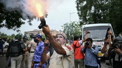 A police personnel fires tear gas shells to disperse activists and supporters of the Cockroach Janta Party (CJP) during a protest demanding the resignation of India's Education Minister Dharmendra Pradhan over alleged NEET examination irregularities in New Delhi on July 20. (AFP) A police personnel fires tear gas shells to disperse activists and supporters of the Cockroach Janta Party (CJP) during a protest demanding the resignation of India's Education Minister Dharmendra Pradhan over alleged NEET examination irregularities in New Delhi on July 20. (AFP)