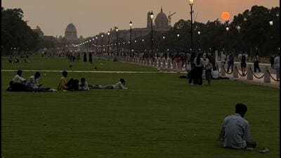 In Connaught Place, after sundown, a bald man in a black suit and tie is sitting alone, without even a mobile phone, on a low cement ledge close to Anil Book Corner, shut for the day. He is looking down. (HT Photo) In Connaught Place, after sundown, a bald man in a black suit and tie is sitting alone, without even a mobile phone, on a low cement ledge close to Anil Book Corner, shut for the day. He is looking down. (HT Photo)