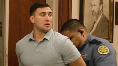 Jake Lang is led out of Judge H. Reid Poland III's courtroom in handcuffs during livestreamer Dalton Eatherly's hearing, Thursday, May 21, 2026, in Clarksville, Tenn. (AP Photo/Kristin Hall)