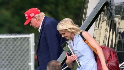 US President Donald Trump and aide Natalie Harp (R) exit Marine One on the Ellipse near the White House on August 16, 2026. (AFP) US President Donald Trump and aide Natalie Harp (R) exit Marine One on the Ellipse near the White House on August 16, 2026. (AFP)