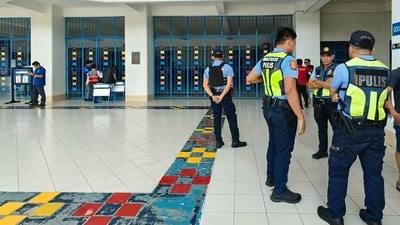 Philippine police gather at a school following a shooting in Zamboanga on August 18, 2026. A student was shot dead at a high school in the southern Philippines on August 18 before the alleged killer took his own life, police said. (Photo by Roel Parreno / AFP) (AFP) Philippine police gather at a school following a shooting in Zamboanga on August 18, 2026. A student was shot dead at a high school in the southern Philippines on August 18 before the alleged killer took his own life, police said. (Photo by Roel Parreno / AFP) (AFP)