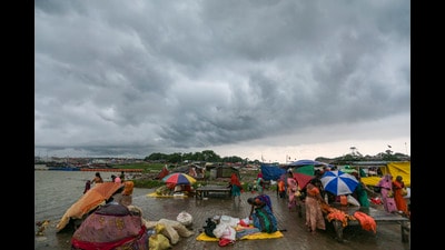 People arrange shelters and umbrellas amid dark monsoon clouds, at Sangam in Prayagraj, Tuesday (PTI) People arrange shelters and umbrellas amid dark monsoon clouds, at Sangam in Prayagraj, Tuesday (PTI)