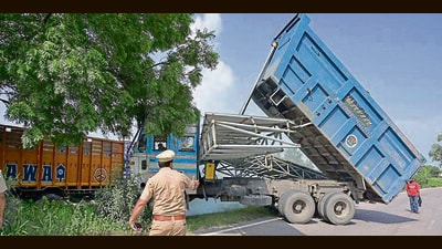 The tripper truck after the accident on the National Highway near Ladhowal on Tuesday; and (right) the bike crushed under the structure. (Gurpreet Singh/ht) The tripper truck after the accident on the National Highway near Ladhowal on Tuesday; and (right) the bike crushed under the structure. (Gurpreet Singh/ht)