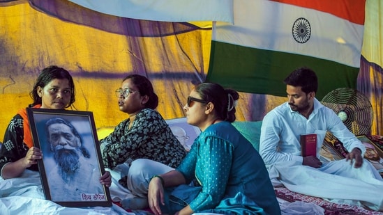 Ranchi, Aug 17 (ANI): One of the students on a hunger strike holds the portrait of Padma Bhushan awardee and former state CM late Shibu Soren on the twenty-third day of the protest against the alleged JSS CGL and JPSC exam paper leak at Jaipal Singh Stadium, in Ranchi on Monday. (ANI Photo) (Somnath Sen)
