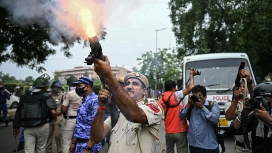 A police personnel fires tear gas shells to disperse activists and supporters of the Cockroach Janta Party (CJP) during a protest demanding the resignation of India's Education Minister Dharmendra Pradhan over alleged NEET examination irregularities in New Delhi on July 20. (AFP)