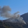Smoke billows from the site of a helicopter crash on the island of Sifnos, Greece.