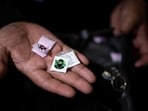 File image: An officer holds small packets of cocaine and tusi seized during an operation