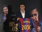 Spanish international footballer Rodri poses with a jersey bearing his name during his official presentation as FC Barcelona's new player on August 18