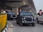 The footage reportedly shows a convoy including a black Mahindra Thar stopping on the busy expressway while a man waves the tricolour. (Screengrab)
