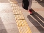 The yellow tiles with raised patterns are to help the visually impaired navigate the urban landscape. 