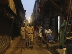 Police officials patrol in a lane during lockdown at the Dharavi slum, a Covid-19 hotspot in Mumbai.