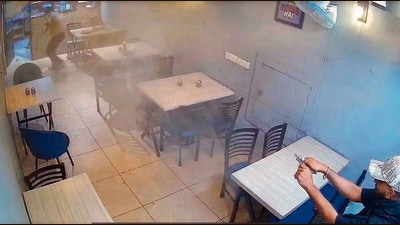 A CCTV grab shows a man firing inside the restaurant at Bhai Randhir Singh (BRS) Nagar, in Ludhiana on Wednesday. (HT photo) A CCTV grab shows a man firing inside the restaurant at Bhai Randhir Singh (BRS) Nagar, in Ludhiana on Wednesday. (HT photo)