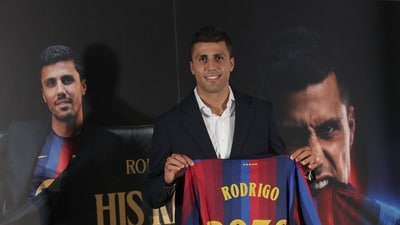 Spanish international footballer Rodri poses with a jersey bearing his name during his official presentation as FC Barcelona's new player on August 18 (AFP)