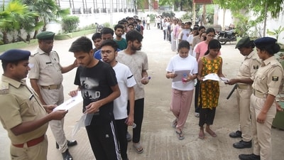 NEET 2026 exam cancelled LIVE updates: Security persons checking aspirants before appearing in the NEET-UG 2026 exam conducted by NTA at an examination centre, Magadh Mahila College in Patna, Bihar (Santosh Kumar/Hindustan Times))