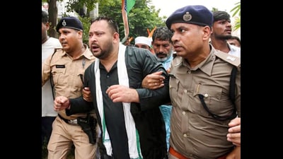 Police detain RJD national working president Tejashwi Yadav during a protest march towards the Bihar Lok Bhawan in Patna, Wednesday. (SANTOSH KUMAR/HT) Police detain RJD national working president Tejashwi Yadav during a protest march towards the Bihar Lok Bhawan in Patna, Wednesday. (SANTOSH KUMAR/HT)