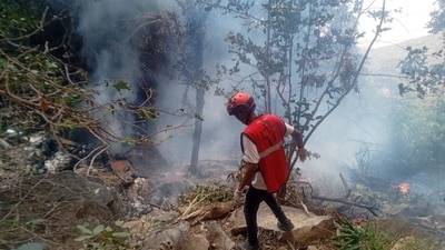 A rescue official works at the site of a tourist helicopter crash that caused multiple casualties, according to the police, in Samburu County, Kenya, August 19, 2026. (via REUTERS)