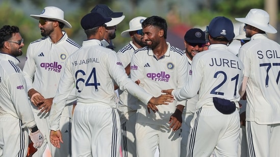 India's Manav Suthar and teammate celebrate the wicket of Sri Lanka's Lahiru Udara on day 4 of the 1st Test match, at Galle International Stadium