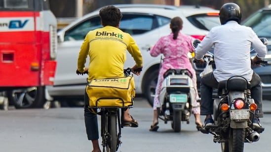 A Blinkit delivery worker pedles a bicycle, in Mumbai (PTI)