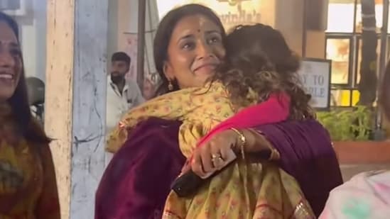 Shriya Saran's daughter Radha clung to her as she got photographed.