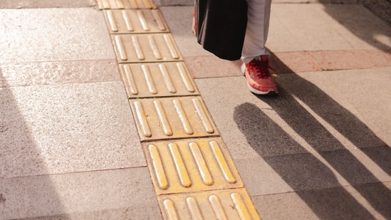 The yellow tiles with raised patterns are to help the visually impaired navigate the urban landscape.