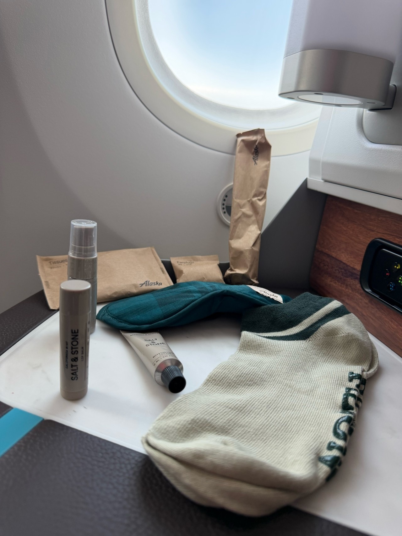 Alaska’s business class amenity kit includes skin care, socks, ear plugs and more. Alaska’s business class amenity kit includes skin care, socks, ear plugs and more.