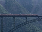 A Vande Bharat train runs on the railway track of the Chenab Bridge, in Reasi, Jammu and Kashmir.