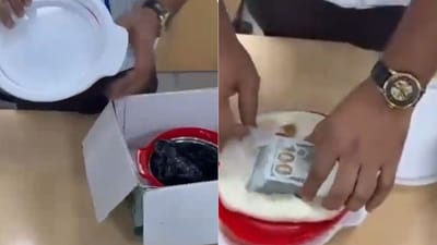 A thorough examination of the passenger's checked-in baggage led to the recovery of USD 15,500. The foreign currency was concealed in a fake bottom of the baggage and inside the cap of a casserole. (X/Delhi Customs) A thorough examination of the passenger's checked-in baggage led to the recovery of USD 15,500. The foreign currency was concealed in a fake bottom of the baggage and inside the cap of a casserole. (X/Delhi Customs)