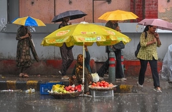 Gram it: As commuters huddled under umbrellas and navigated rain-soaked Connaught Place during Wednesday’s downpour, the Capital once again slipped into monsoon mode. The wet spell is set to linger, with the India Meteorological Department forecasting a generally cloudy sky and very light to light rain for Friday, August 21. (Photo: RAJ K RAJ/HT)