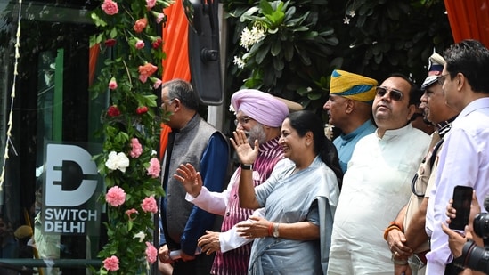 Lieutenant Governor of Delhi Sardar Taranjit Singh Sandhu with Delhi CM Rekha Gupta and Delhi Transport Minister Pankaj Kumar Singh during the inaugration of Ladies Special DEVI (Delhi Electric Vehicle Interconnector) buses at Delhi University Sports Complex. (HT Photo/Ishant Chauhan)