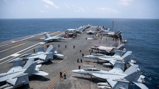 US sailors work on the flight deck of USS George Washington (CVN 73), Aug. 20, as the aircraft carrier transits the Arabian Sea. 