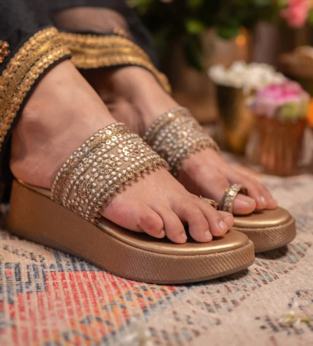 Naksh features antique-gold and pearl-work Kolhapuri straps with platform heels. (Coral Haze) Naksh features antique-gold and pearl-work Kolhapuri straps with platform heels. (Coral Haze)