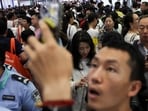 Visitors walk past booths at an exhibition hall during the 2026 World Robot Conference, in Beijing, China August 21, 2026. REUTERS/Tingshu Wang