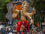 Devotees carry the Lord Ganesha idol ahead of Ganesh festival from Parel workshop. (Satish Bate/ Hindustan Times)