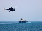 An Indian Navy Chetak helicopter carries out aerial security patrols above a commercial crude oil tanker navigating through the Bab-el-Mandeb strait, between the Red Sea and the Gulf of Aden.