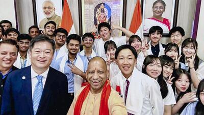 Chief minister Yogi Adityanath poses for photographs with students from Japan and India during an interaction, in Lucknow. (@CMOfficeUP/X via PTI Photo)