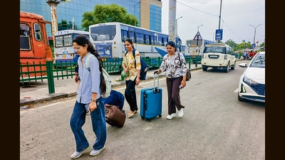 Passengers drag their luggage after Qaumi Insaaf Morcha supporters blocked movement of buses at the Patiala bus stand. (PTI) Passengers drag their luggage after Qaumi Insaaf Morcha supporters blocked movement of buses at the Patiala bus stand. (PTI)