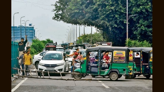 A road near the bus stand blocked by protesters; supporters of Qaumi Insaaf Morcha placing a barricade on the Jalandhar highway near Ladhowal police station. (HT)